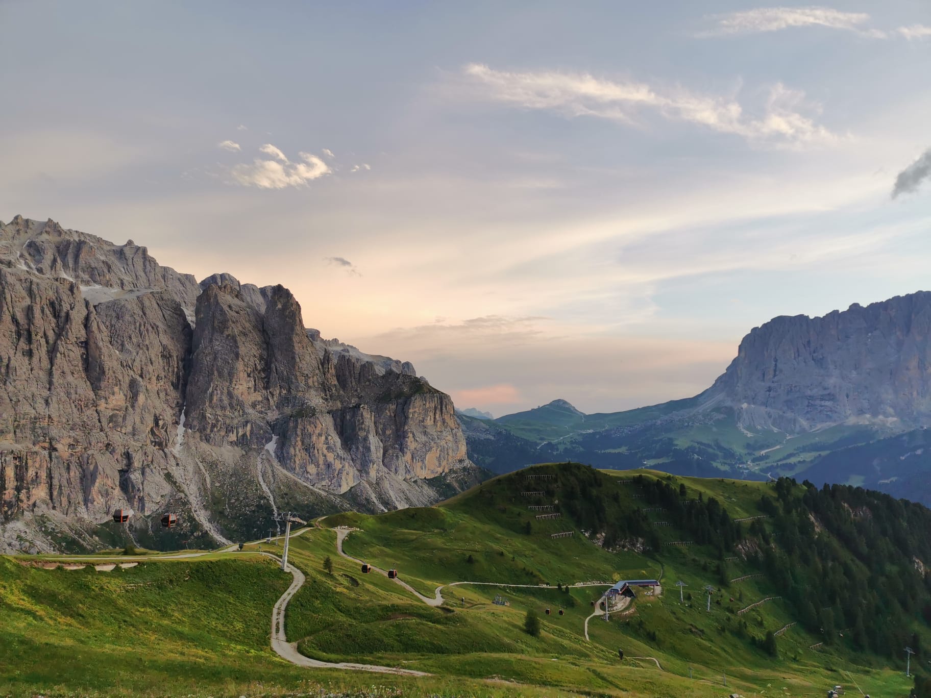 Dolomites massifs at sunset above alpine meadows, Italy